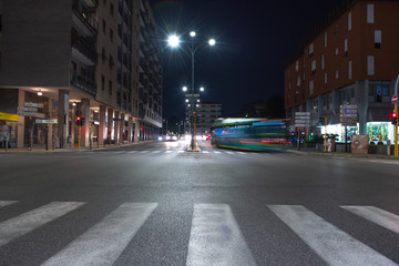 Timelapse view of traffic at an urban night intersection. Urban movement in the Italian city in the evening.