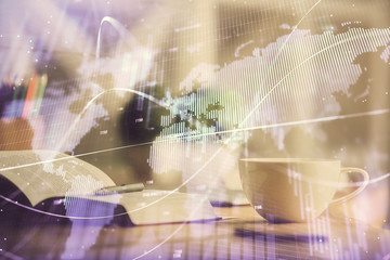 Multi exposure of forex graph drawing and desktop with coffee and items on table background. Concept of financial market trading