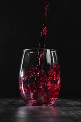 red wine pouring into glass