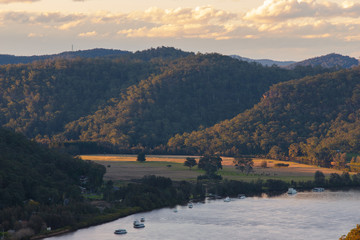 Golden light over the hill next to the river.