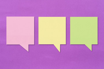 Colorful square note paper on purple paper background.