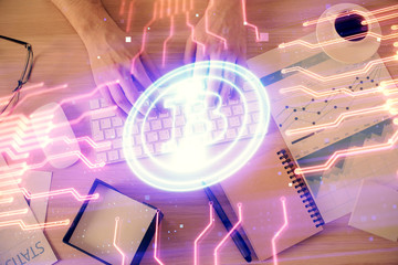 Double exposure of man's hands typing over computer keyboard and crypto currency theme hologram drawing. Top view. Blockchain concept.