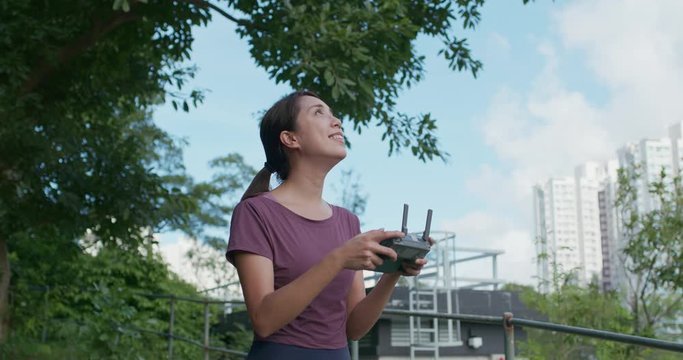 Woman control fly drone at outdoor