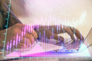 Double exposure of businesswoman hands typing on computer and forex chart hologram drawing. Financial analysis concept.