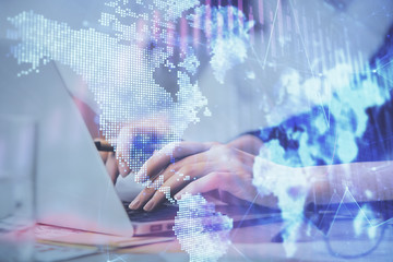 Multi exposure of woman hands typing on computer and financial graph hologram drawing. Stock market...