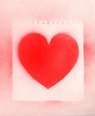 Spray paint heart sign, shape heart graffiti on white paper background with perforation traces