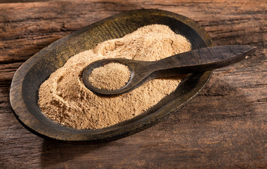 Organic maca powder in the wooden bowl - Lepidium meyenii.