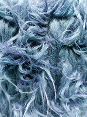 Close up of a blue dyed sheepskin rug as a background