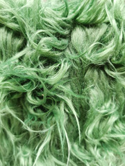 Close up of a green dyed sheepskin rug as a background