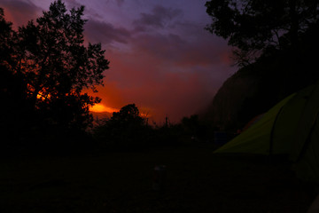 Amanecer con nubes y sol rojo