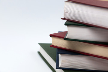 Book stack on a white background. Education concept side view close up