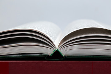 Open book on white background. Side view close up