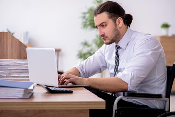 Young disabled employee suffering at workplace