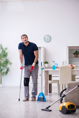 Young leg injured contractor cleaning the house