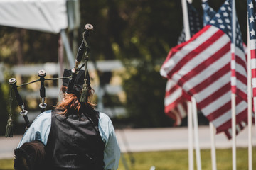 Bagpipe memorial service with flags 