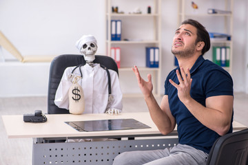 Young man visiting dead doctor in expensive medicine concept