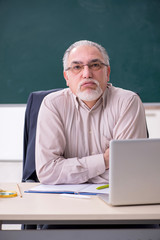 Old male teacher in the classroom