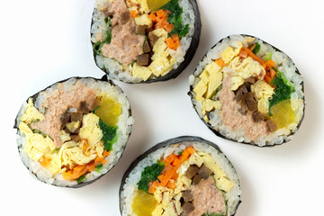 Korean gimbap rolls isolated on white background close-up, top view
