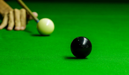 Man playing snooker balls on green snooker table