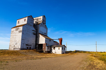 An old abandoned grain elevator in the town of Leney in the prairie province of Saskatchewan, Canada. These elevators were once used to store wheat and other grains before it was loaded onto trains