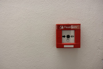 The red box with black alarm button for calling the fire department