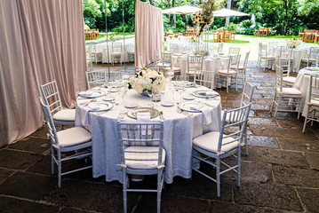Elegant outdoors summer wedding with flowers decoration and mirrors