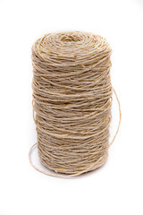 A roll or coil of natural rope or jute twine on white background