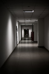empty long corridor stretching into the future. The concept of holidays, quarantine, evacuation in the office building.