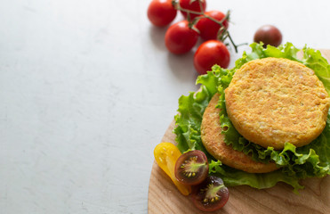 Fresh vegan chickpea burger (cutlets), tomatoes and lettuce. Home made with vegetables and chickpeas.The concept of healthy and vegetarian food. Place for text. Plant based food concept.