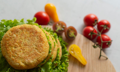 Fresh vegan chickpea burger (cutlets), tomatoes and lettuce. Home made with vegetables and chickpeas.The concept of healthy and vegetarian food. Place for text. Plant based food concept.