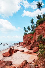 Tropical island red cliff  rock beach with blue sky and clouds in summer, tranquil serene ocean scenery. Fang Daeng in Prachuap Khiri Khan. Thailand