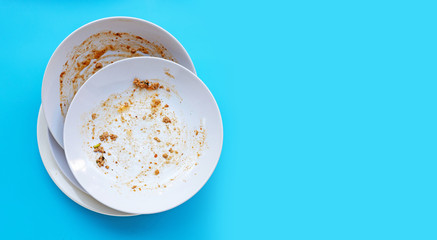 Dirty dishes on blue background.