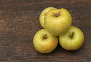 Fresh apples on a wooden background. White apples