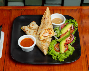 Beef Burrito with avocado and salad