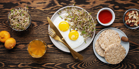 Healthy breakfast with egg, bean sprouts, fruit, honey and juice. Top view. Flat lay
