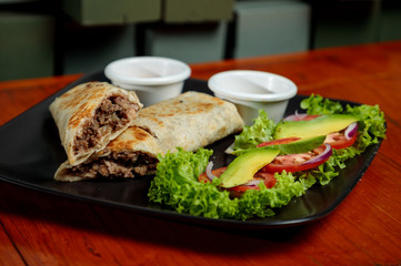 Beef Burrito with avocado and salad