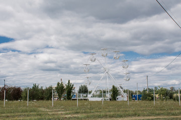 Fototapeta na wymiar Ferris wheel ride in the field