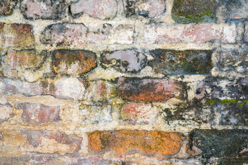 Ancient brick wall stained with time