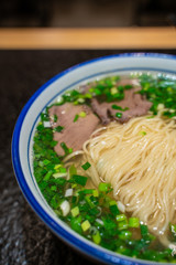 A bowl of traditional Chinese Lanzhou beef noodle soup.