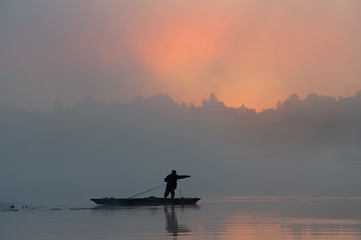 Fototapeta na wymiar Morning, sun, fog, boat, fisherman, fishing rods, river, rest and hobby