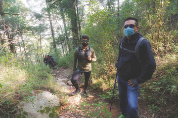 Tourist Group Wear a face mask to prevent COVID-19. Hiking travel