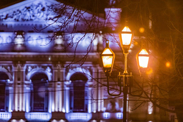 night city street lights old opera building on background