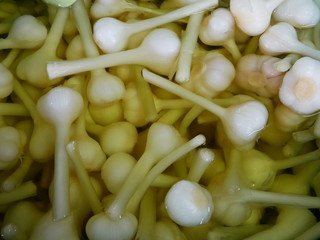 pile of pickled garlic for sale on market.