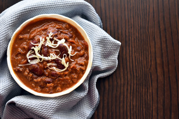 Chilli con carne on a white bowl.  Copy space is on the right side.  Selective focus.