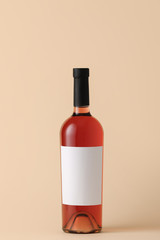 Bottle of wine with blank label on color background. Mockup for design