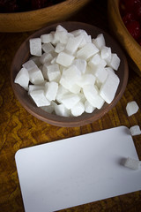 Candied coconut fruits in a clay bowl