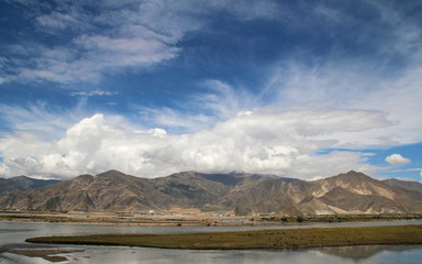 View of mountains and Yarlung Tsangpo river with the dramatic sky in Lhasa, Tibet
