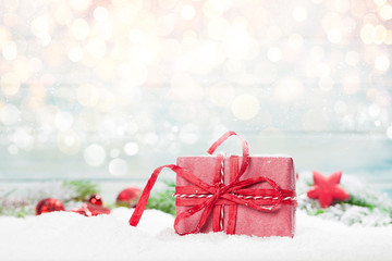 Christmas greeting card with gift box in snow
