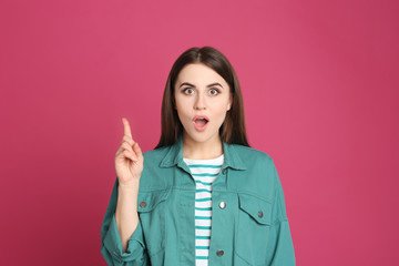 Portrait of emotional young woman on pink background