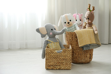 Funny stuffed toys in baskets on floor, space for text. Children's room interior decor © New Africa